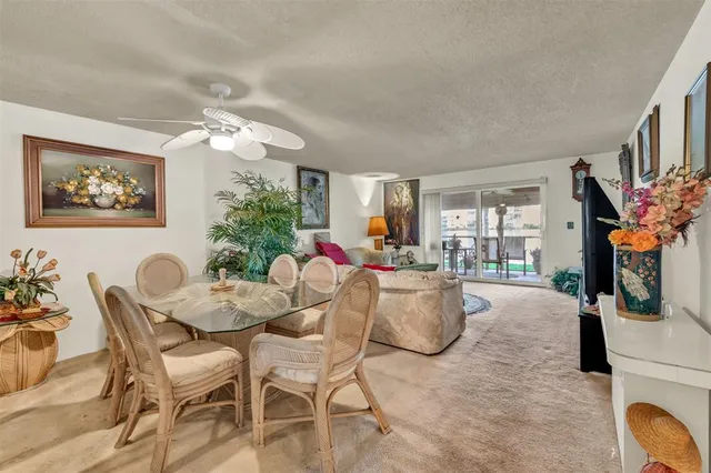 a view of a dining room with furniture and a potted plant