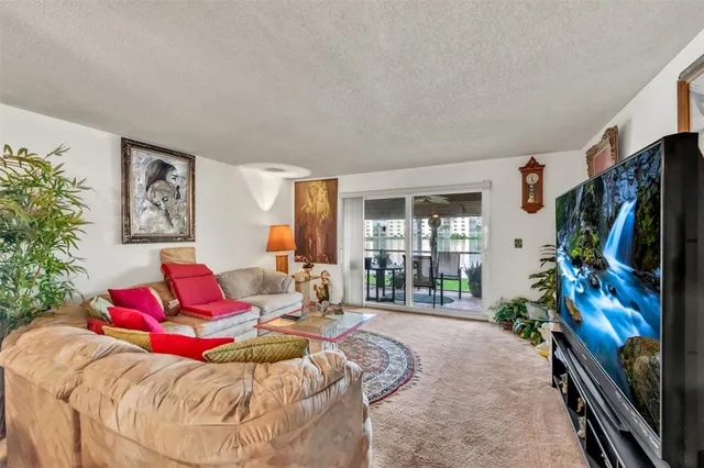 a bedroom with a bed window and flat screen tv