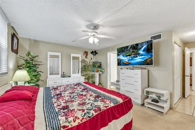 a living room with a rug and a flat screen tv