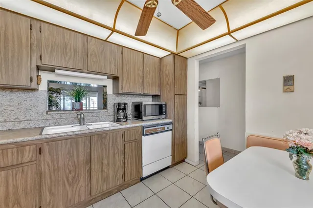 a kitchen with a sink cabinets and window