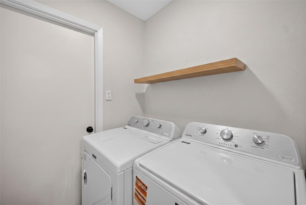 3919 Ridgeoak Way Farmers Branch, TX 75244 - Photo 23 of 28 Laundry area featuring a floating wood-finish shelf and a light-colored wall finish
