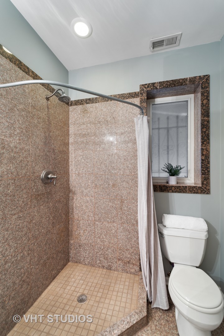 1733 South Ruble Street, Unit 1 Chicago, IL 60616 - Photo 12 of 19 a bathroom with a shower a toilet and a sink