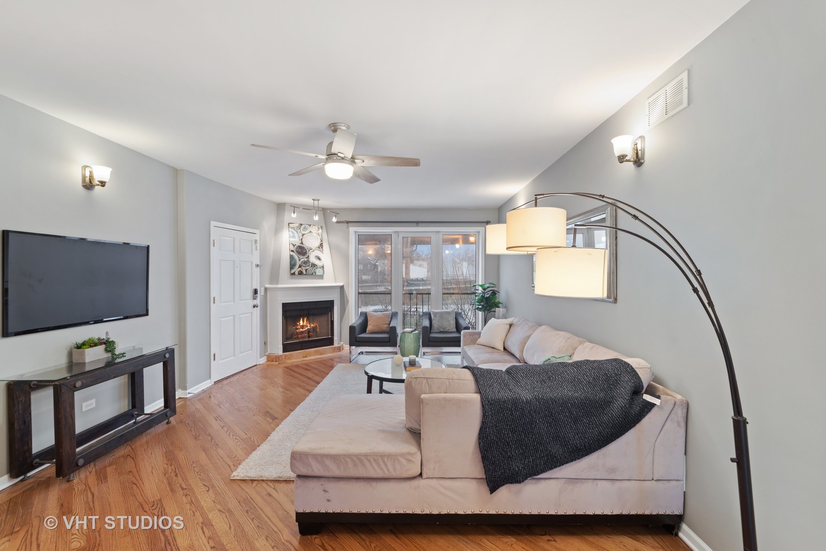 1733 South Ruble Street, Unit 1 Chicago, IL 60616 - Photo 3 of 19 a living room with furniture a fireplace and a flat screen tv
