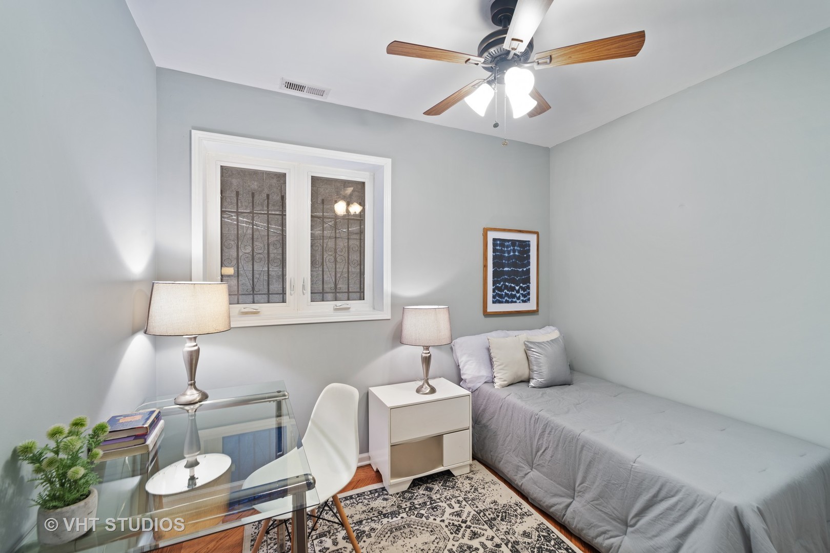1733 South Ruble Street, Unit 1 Chicago, IL 60616 - Photo 10 of 19 a bedroom with a bed and a chandelier