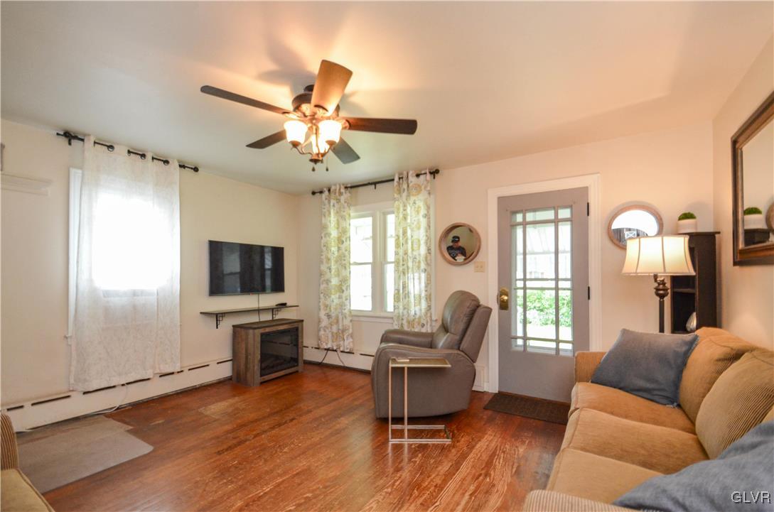 112 Trach Road Kunkletown, PA 18058 - Photo 6 of 33 a living room with furniture a ceiling fan a flat screen tv and a window