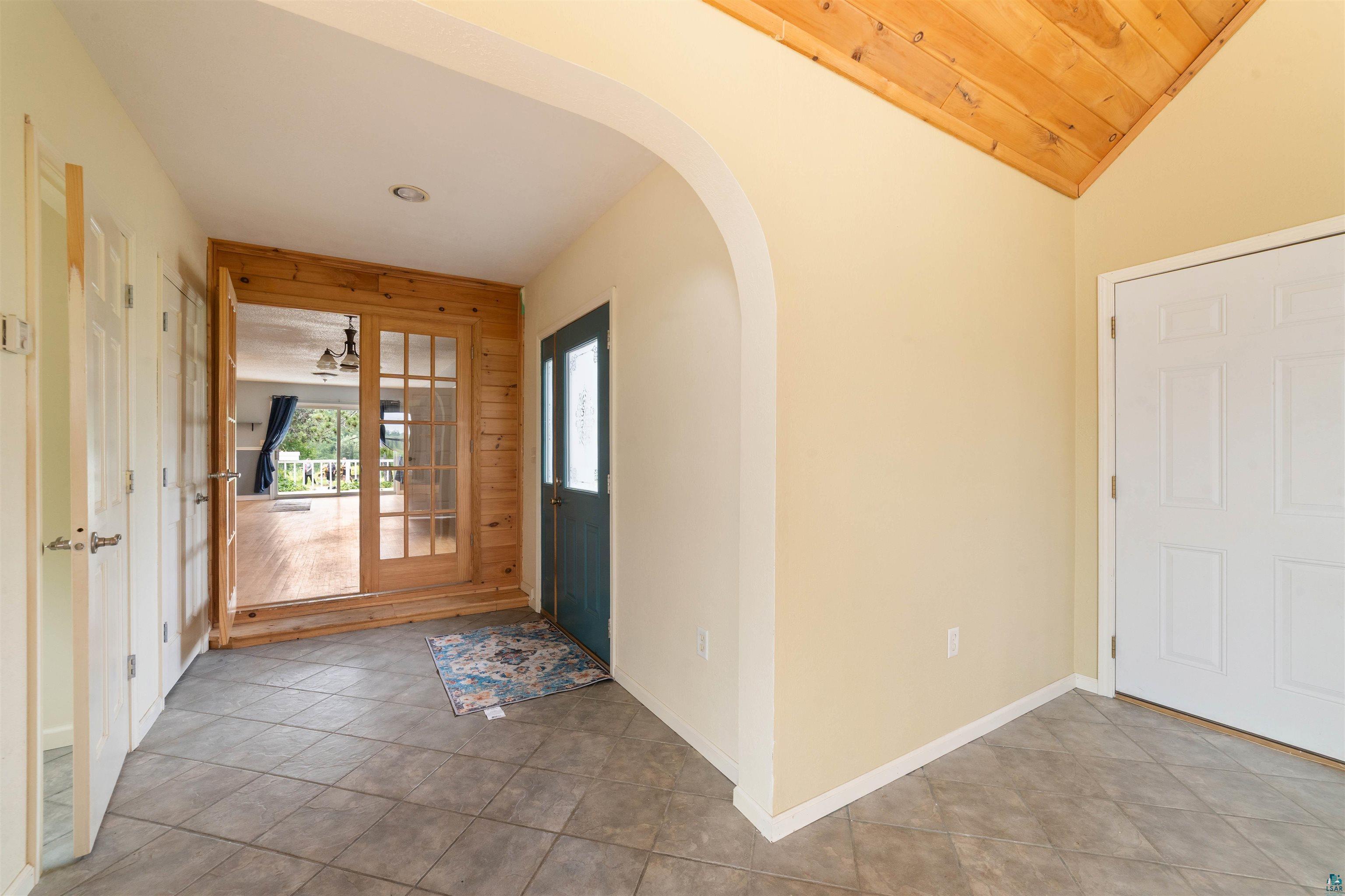 9372 McCamus Road Brookston, MN 55711 - Photo 11 of 49 Tiled foyer featuring arched walkways and vaulted ceiling