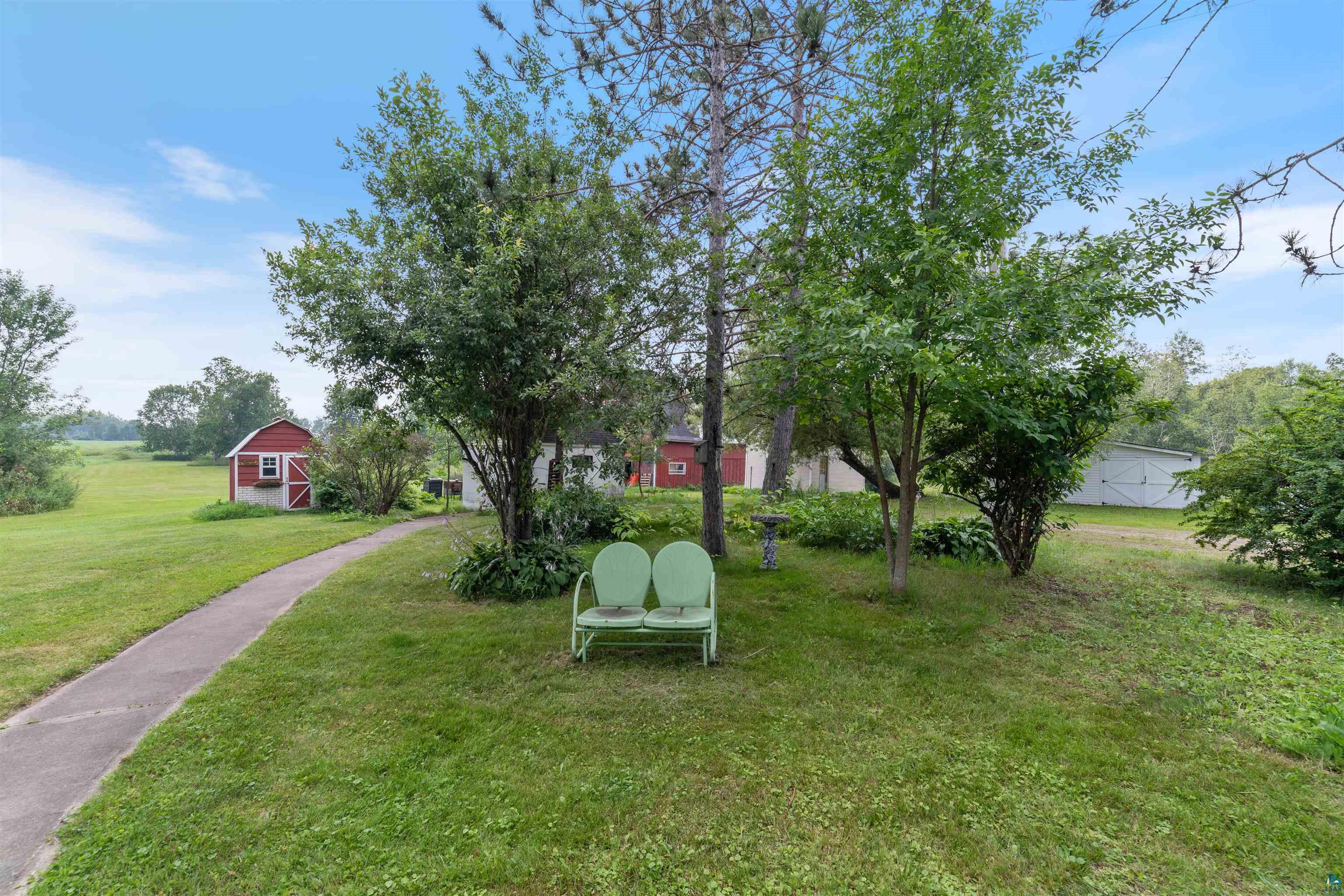 9372 McCamus Road Brookston, MN 55711 - Photo 44 of 49 View of grassy yard featuring a barn and an outdoor structure