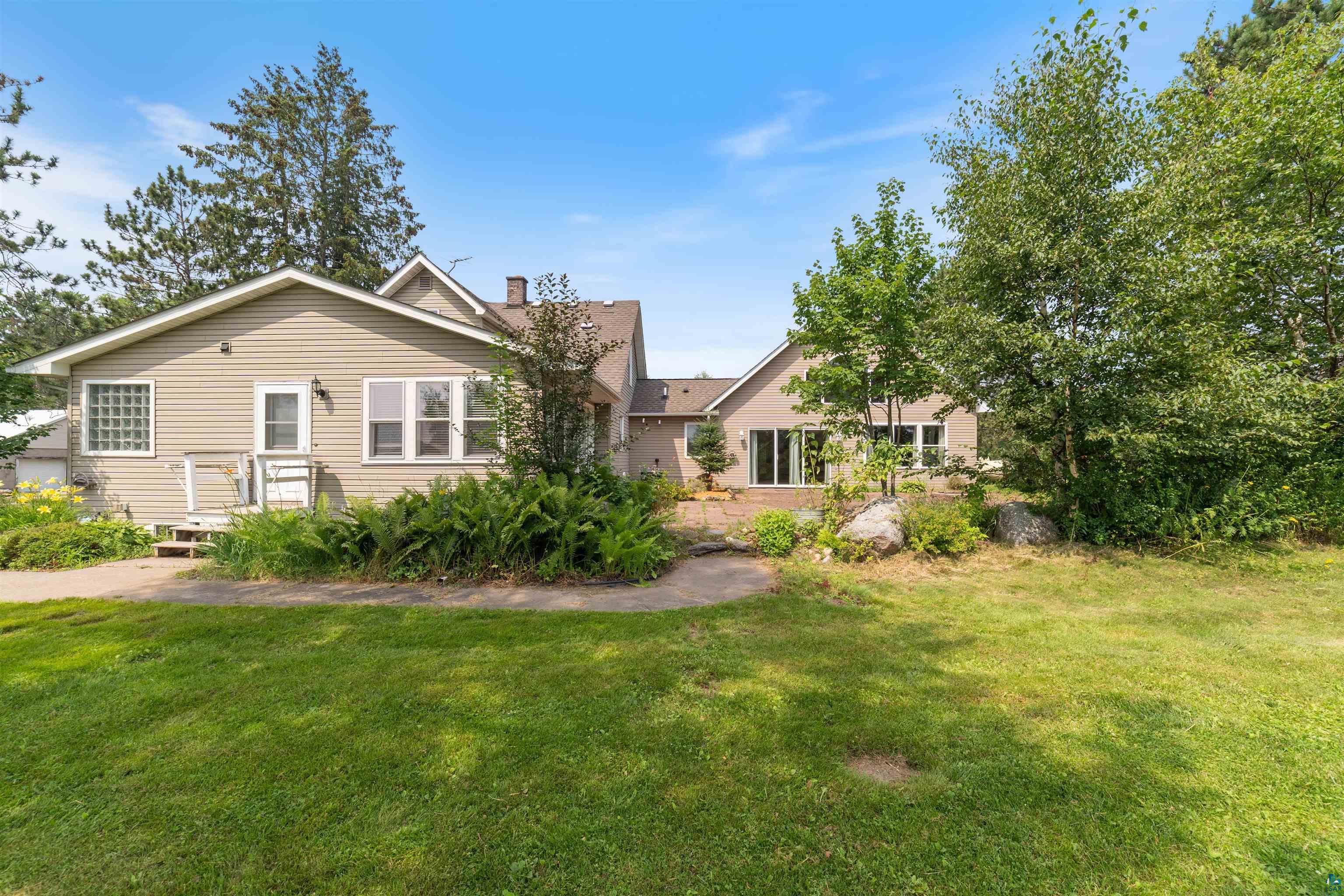 9372 McCamus Road Brookston, MN 55711 - Photo 8 of 49 View of front of house with a front lawn and a chimney