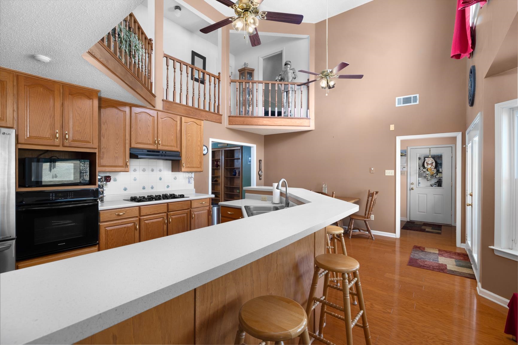 8539 Campground Road Drummonds, TN 38023 - Photo 13 of 38 a kitchen with stainless steel appliances kitchen island granite countertop a table chairs in it and wooden floors