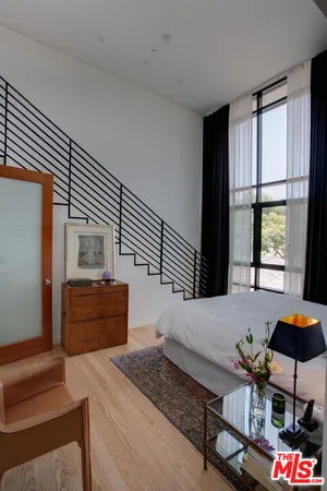 a kitchen with stainless steel appliances kitchen island granite countertop a stove a refrigerator and a dining table chair