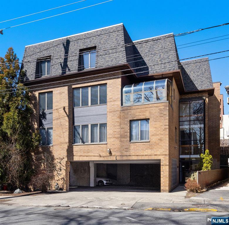 319 Gorge Road, Unit 6 Cliffside Park, NJ 07010 - Photo 2 of 24 a front view of a house with a garden