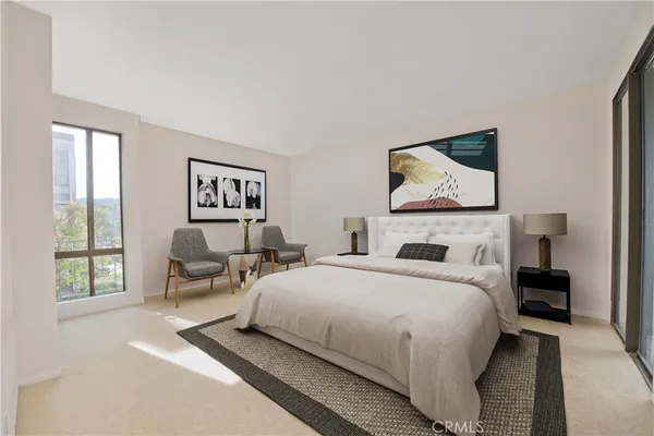 a bedroom with a bed and a large window