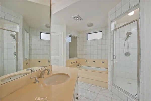 a bathroom with a granite countertop tub sink toilet and shower