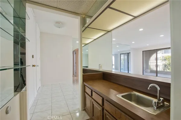 a view of a kitchen with a sink and refrigerator