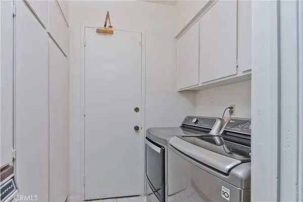 a kitchen with a stove and a white cabinet
