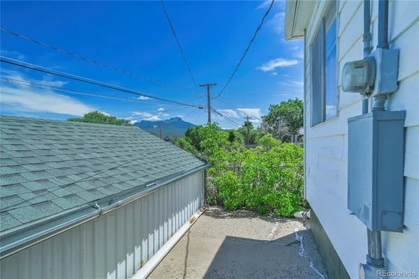 a view of a house with a yard and sitting area