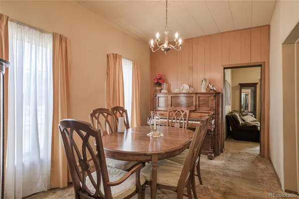 a view of a dining room with furniture and chandelier