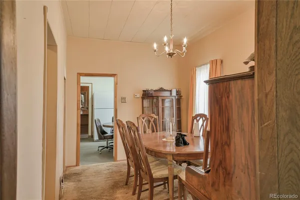a view of a dining room with furniture and chandelier
