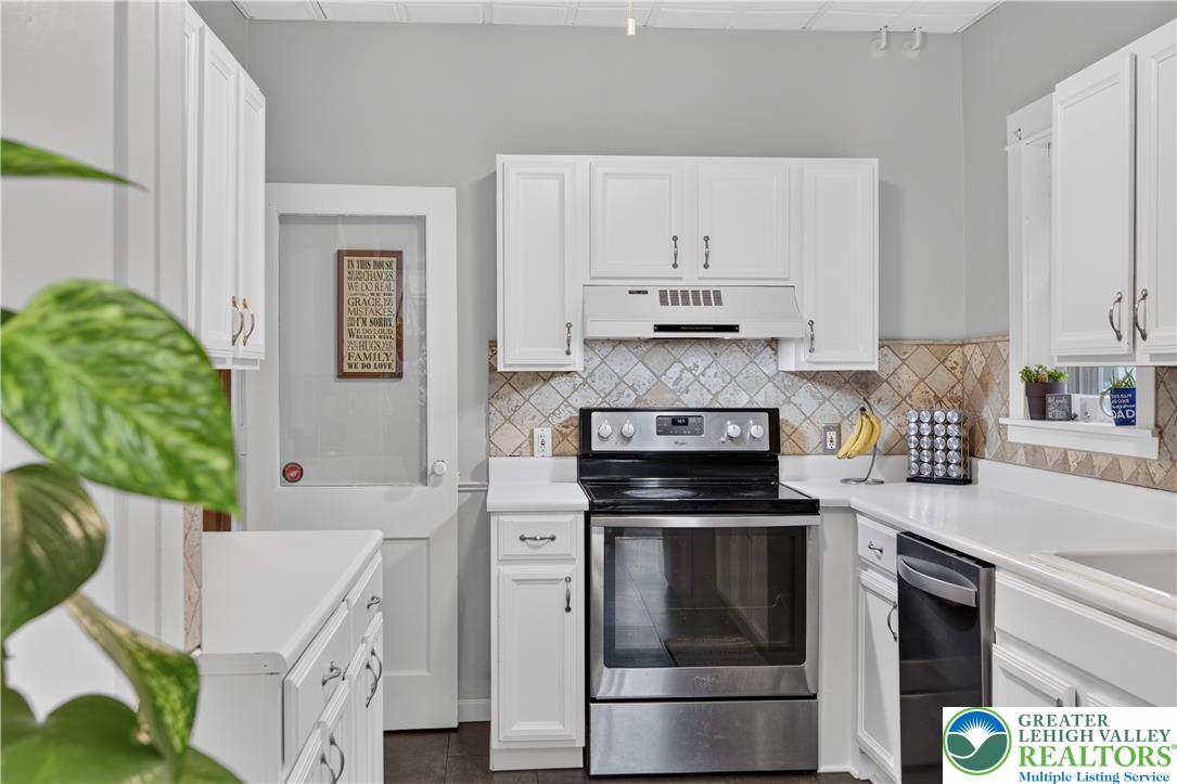 534 Ridge Street Emmaus, PA 18049 - Photo 17 of 40 a kitchen with kitchen island a stove a sink and white cabinets