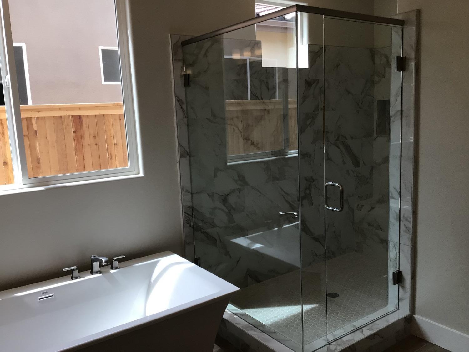 969 Ridgeline Road Madera, CA 93636 - Photo 13 of 16 a bathroom with a shower sink and mirror