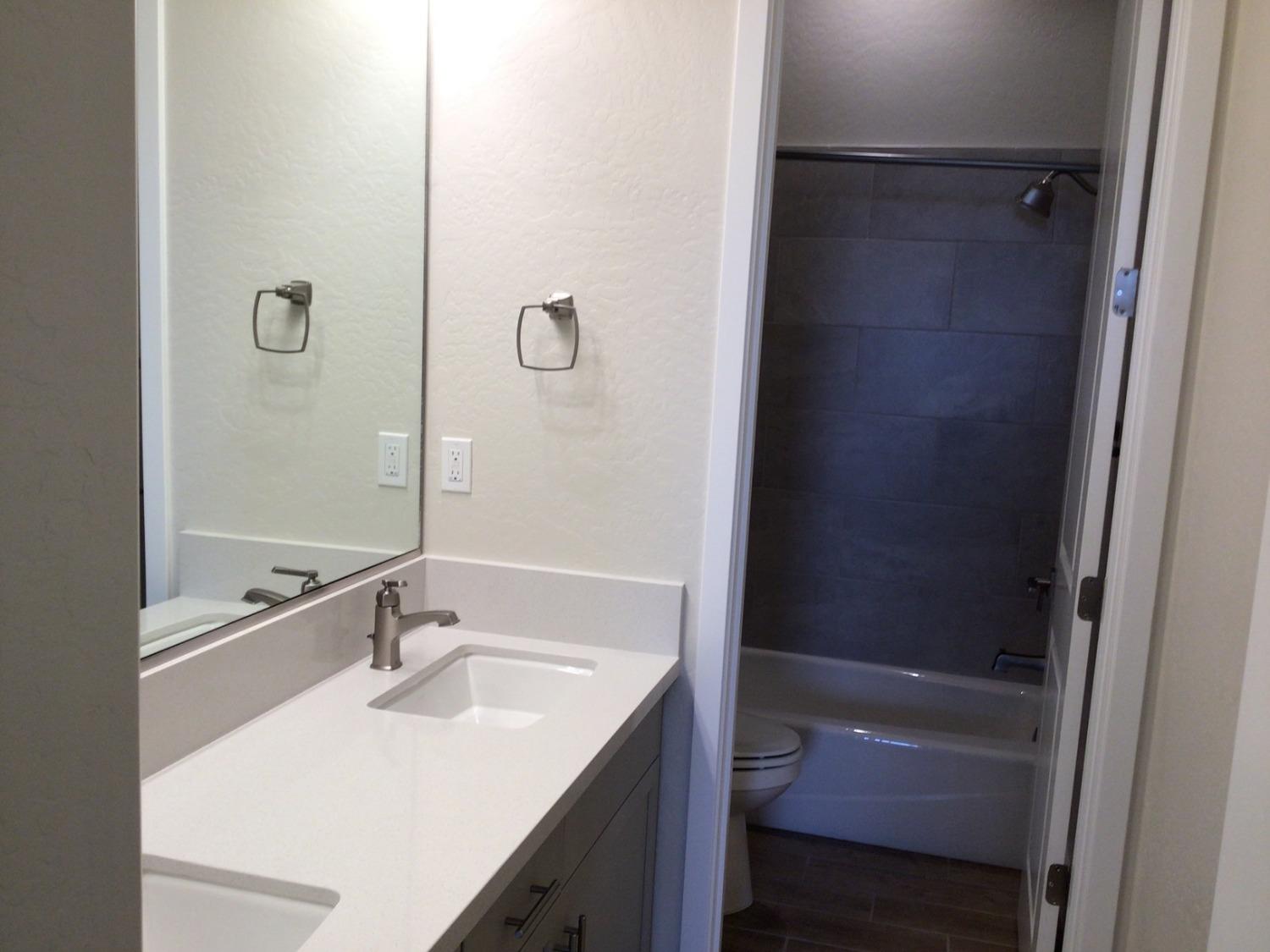 969 Ridgeline Road Madera, CA 93636 - Photo 15 of 16 a bathroom with a sink and a mirror