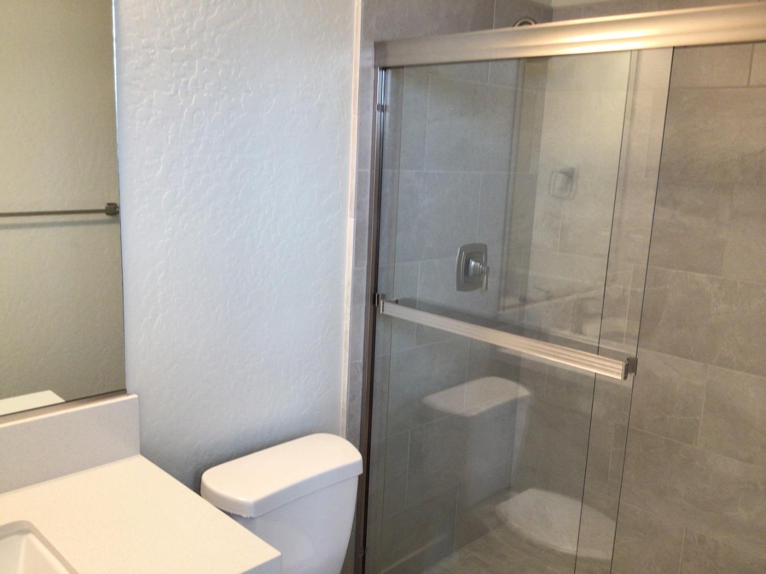 969 Ridgeline Road Madera, CA 93636 - Photo 16 of 16 a bathroom with a shower and a toilet