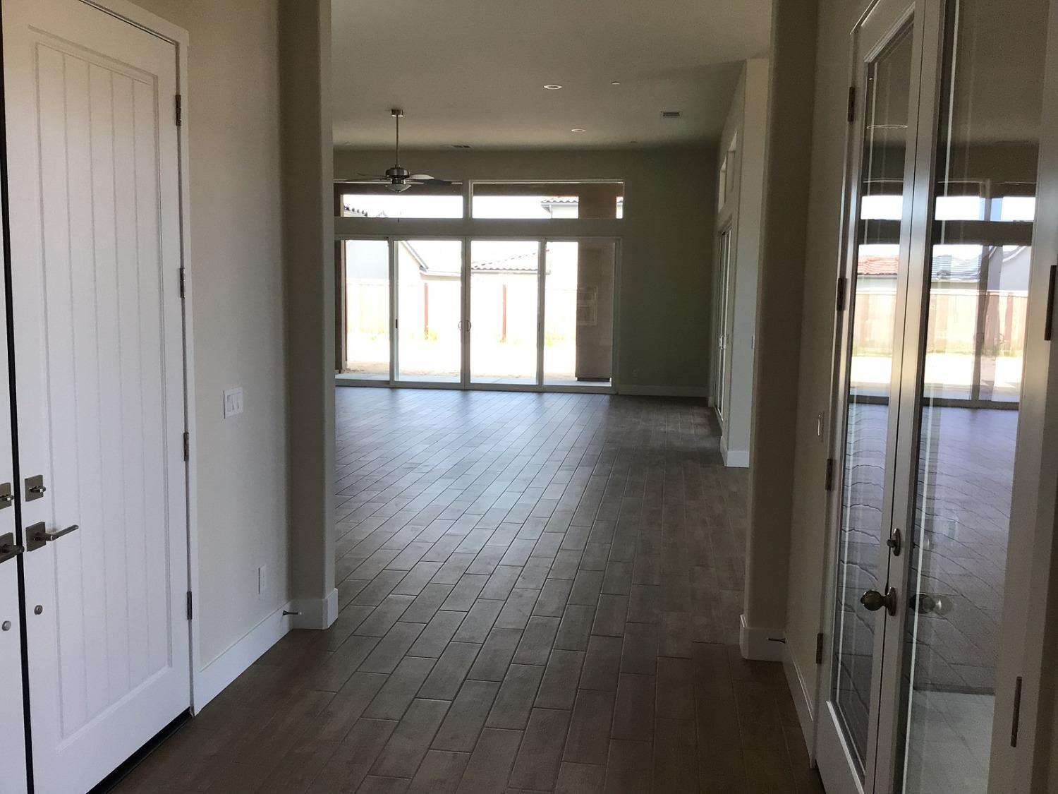 969 Ridgeline Road Madera, CA 93636 - Photo 3 of 16 wooden floor in an empty room with a window