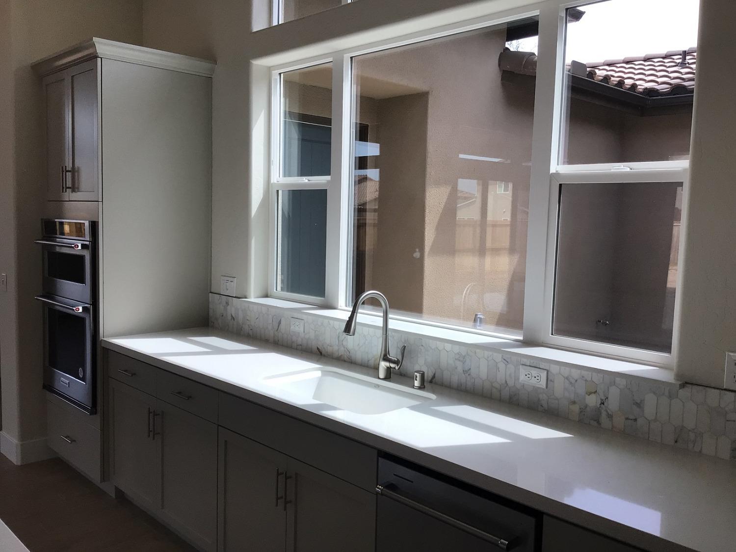 969 Ridgeline Road Madera, CA 93636 - Photo 4 of 16 a bathroom with a granite countertop sink and a mirror