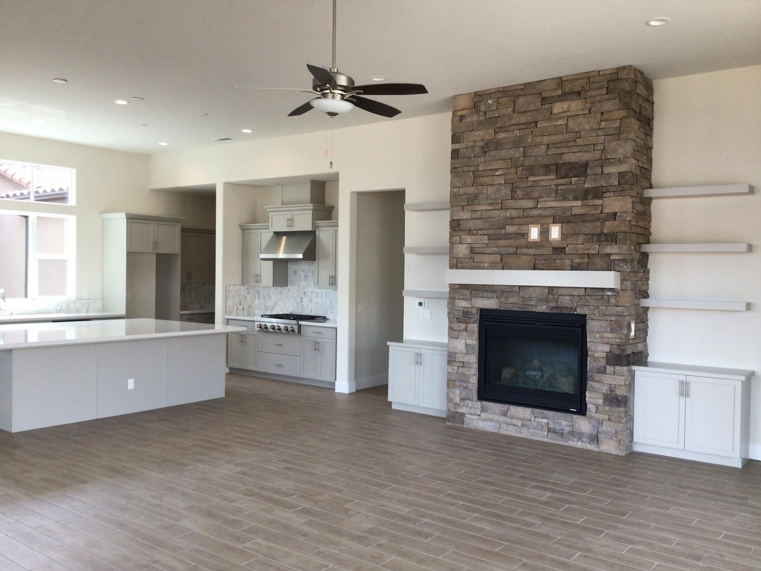 969 Ridgeline Road Madera, CA 93636 - Photo 6 of 16 a living room with stainless steel appliances wooden floor and a fireplace