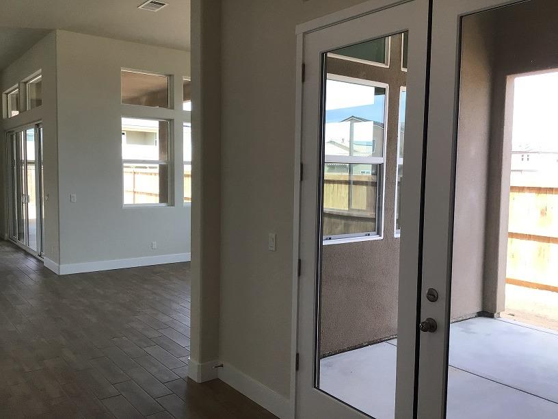 969 Ridgeline Road Madera, CA 93636 - Photo 7 of 16 a view of an empty room with wooden floor and a window