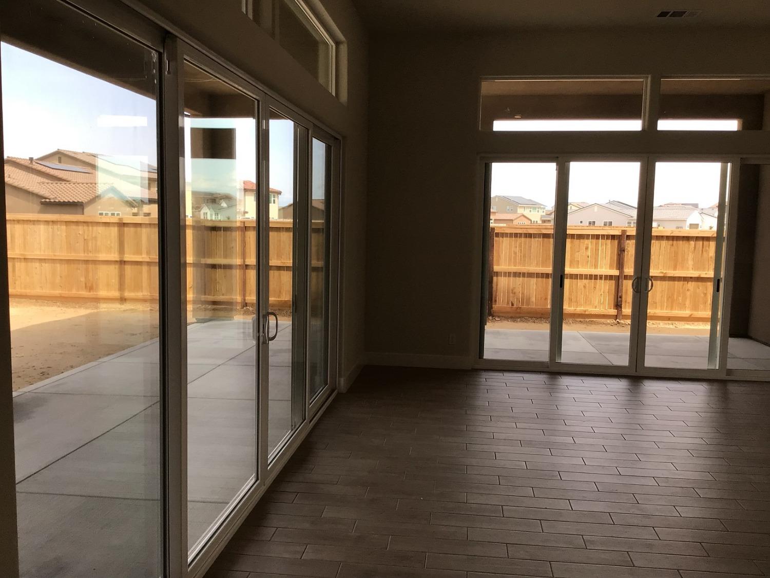 969 Ridgeline Road Madera, CA 93636 - Photo 9 of 16 a view of an empty room with wooden floor and a window