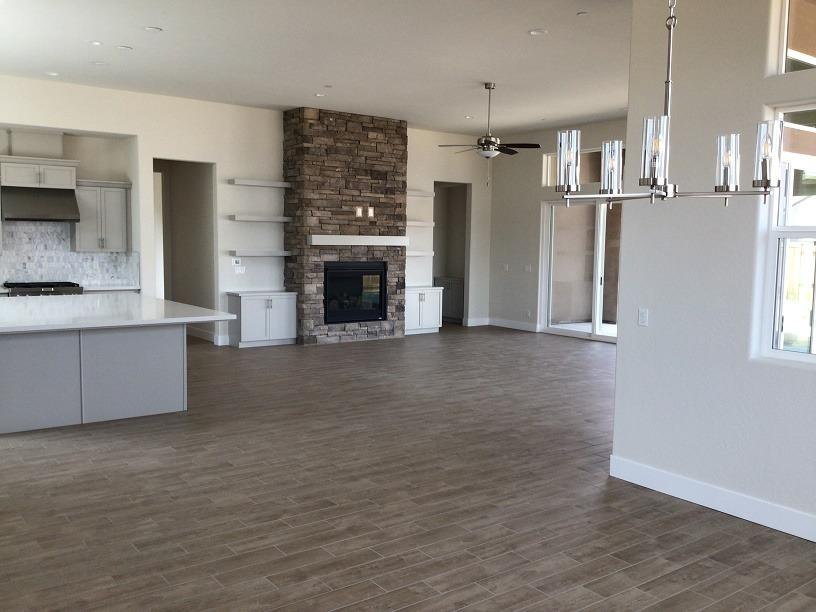 969 Ridgeline Road Madera, CA 93636 - Photo 10 of 16 a view of kitchen and empty room with fireplace