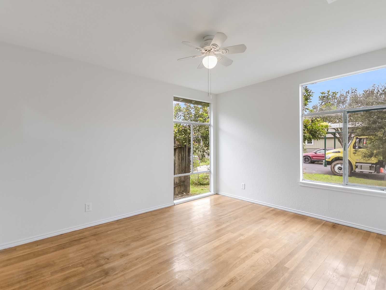 112 East Skyview Road Austin, TX 78752 - Photo 4 of 10 wooden floor in an empty room with a window