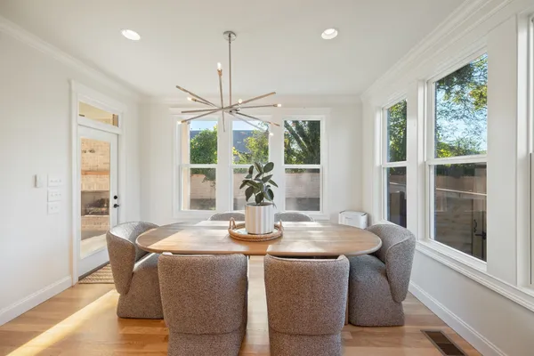 a view of a dining room with furniture wooden floor and chandelier