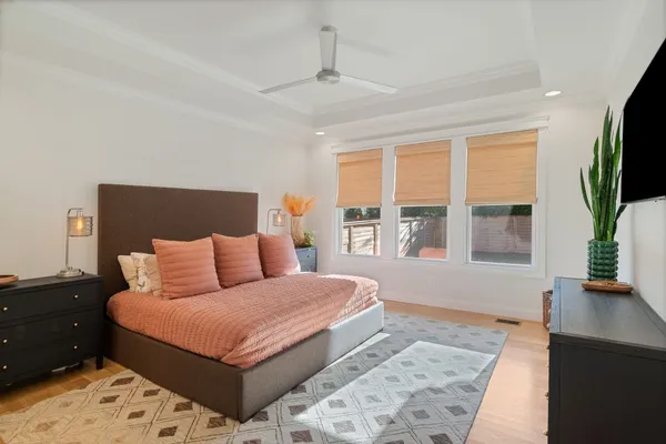 a bedroom with a large bed and a flat screen tv