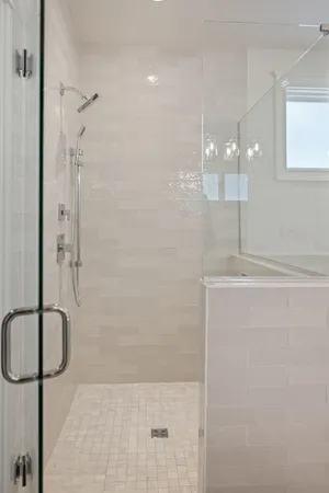 a bathroom with a glass shower door