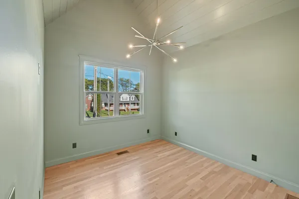 en empty room with window and ceiling fan