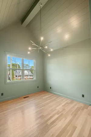 an empty room with a empty space and windows