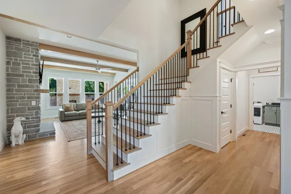 a view of entryway and hall with wooden floor