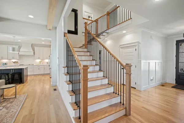 a view of entryway and hall with wooden floor