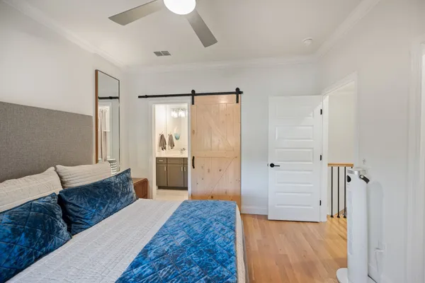 a spacious bedroom with a bed and a dresser