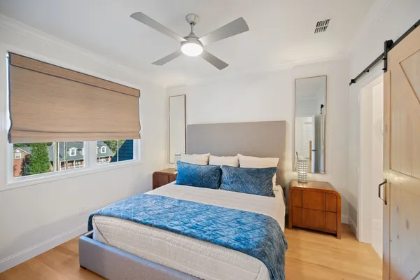 a bedroom with a large bed and a window