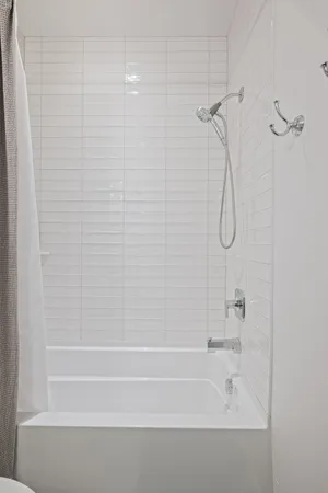 a bathroom with a shower and a bathtub