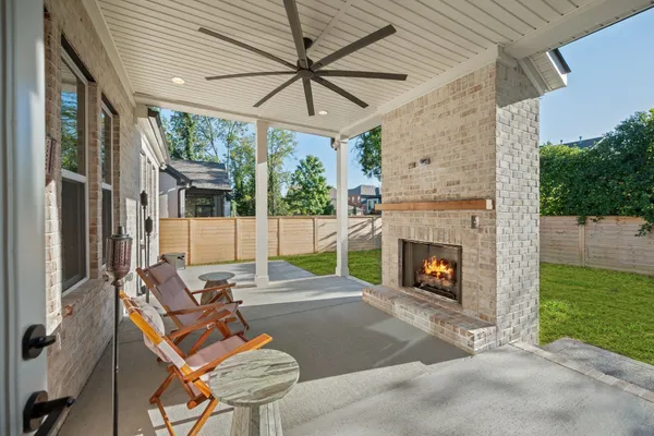 a outdoor space with patio the couches and a fireplace