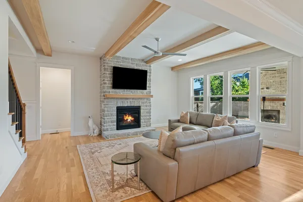 a living room with furniture flat screen tv and a fireplace
