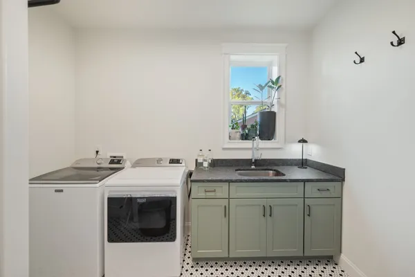 a en suite bathroom with a granite countertop sink and a mirror