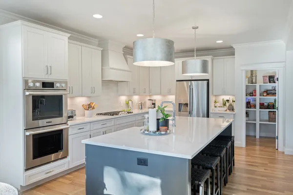 a kitchen with kitchen island a counter space a sink and appliances