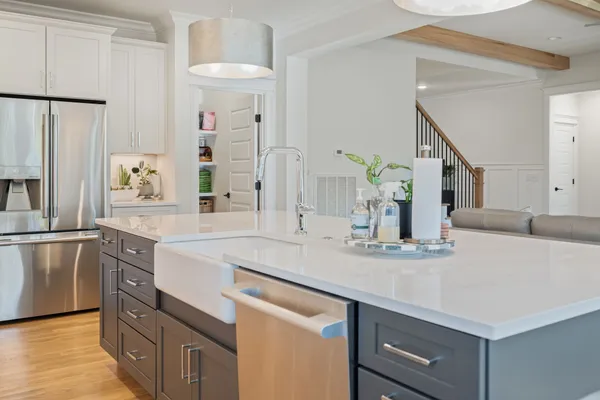 a kitchen with stainless steel appliances granite countertop a sink and a refrigerator