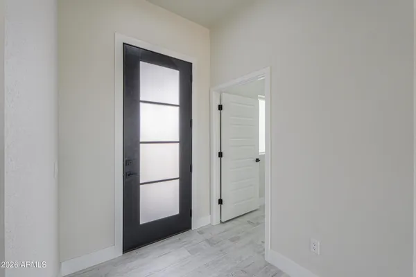 a view of an empty room with a kitchen