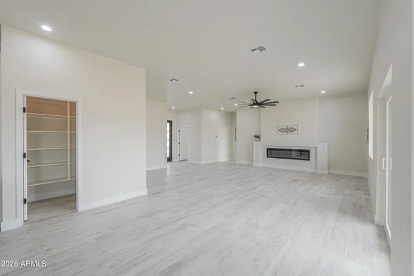 a view of a big room with wooden floor closet and windows